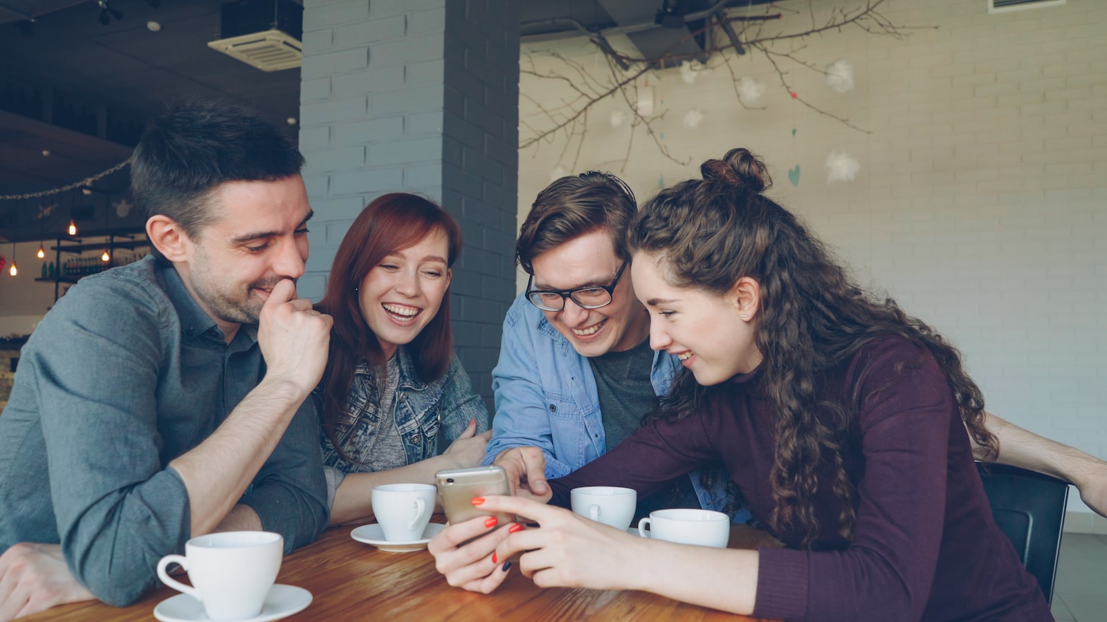Friends sharing and enjoying a smartphone together